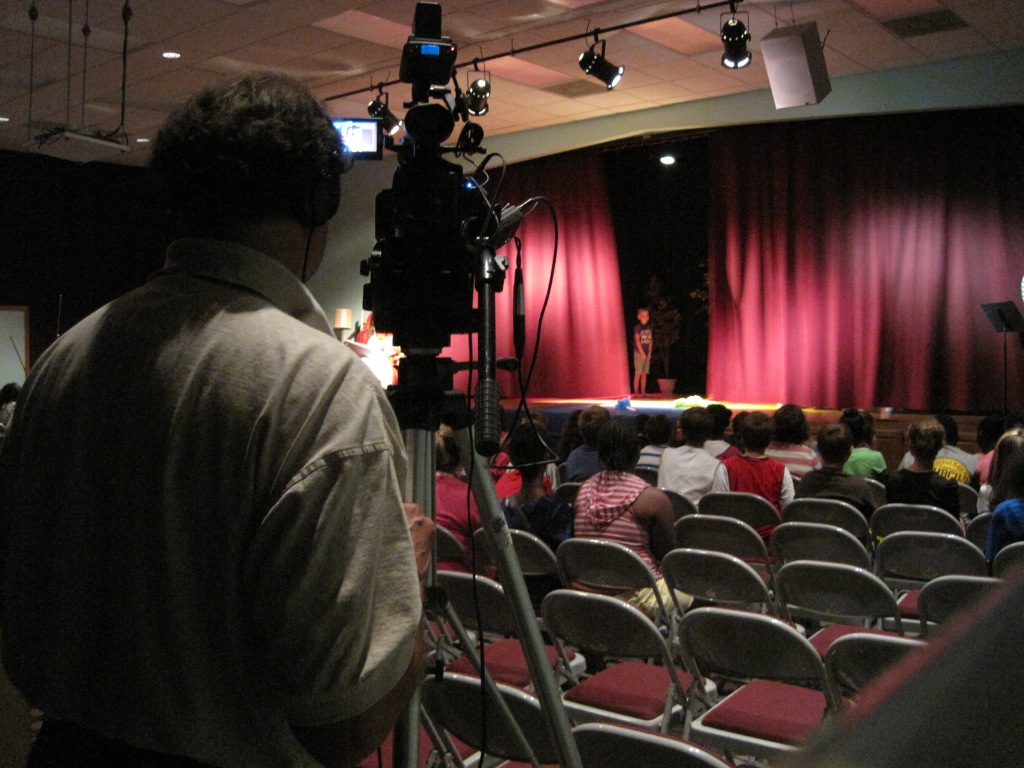 Camera operator on location taping a live venue.